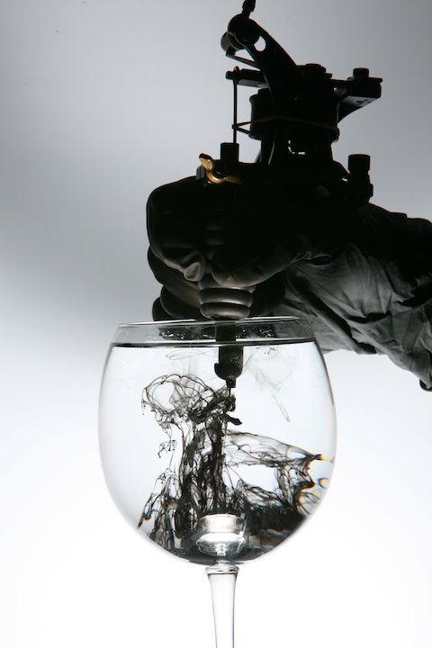 coil tattoo machine getting tipped into water